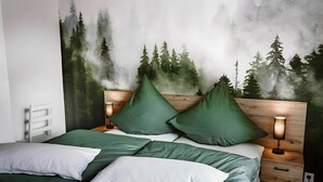 A bed with green and white bedding, a nightstand with a lamp, and a wall mural of a forest. - Holiday Apartment 'Waldfeeling' with Private Terrace and Wi-Fi (Brilon)