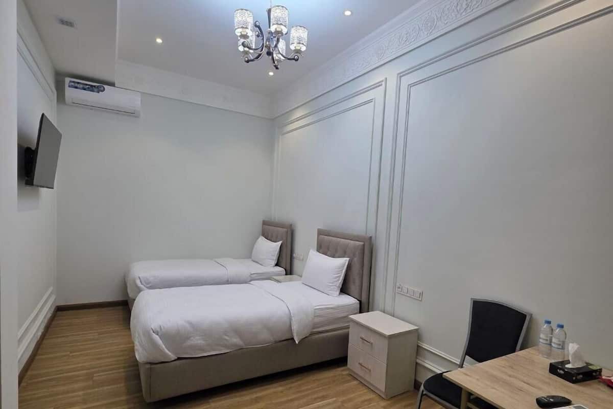 Economy Triple Room | In-room safe, desk, laptop workspace, blackout drapes