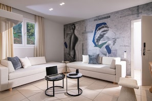 Family Suite | Living area | 28-inch flat-screen TV with cable channels