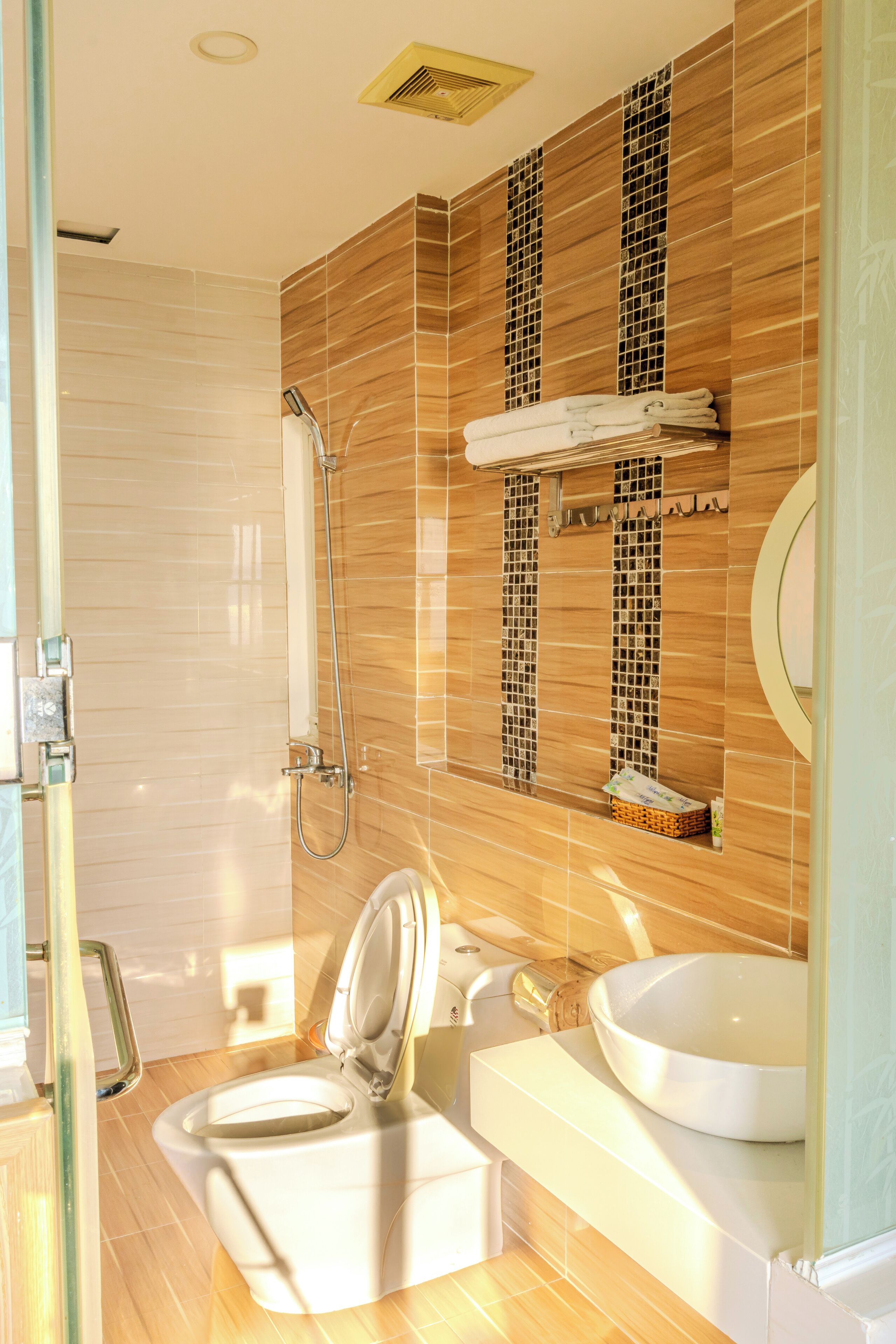 A modern bathroom with a toilet, sink, and shower.