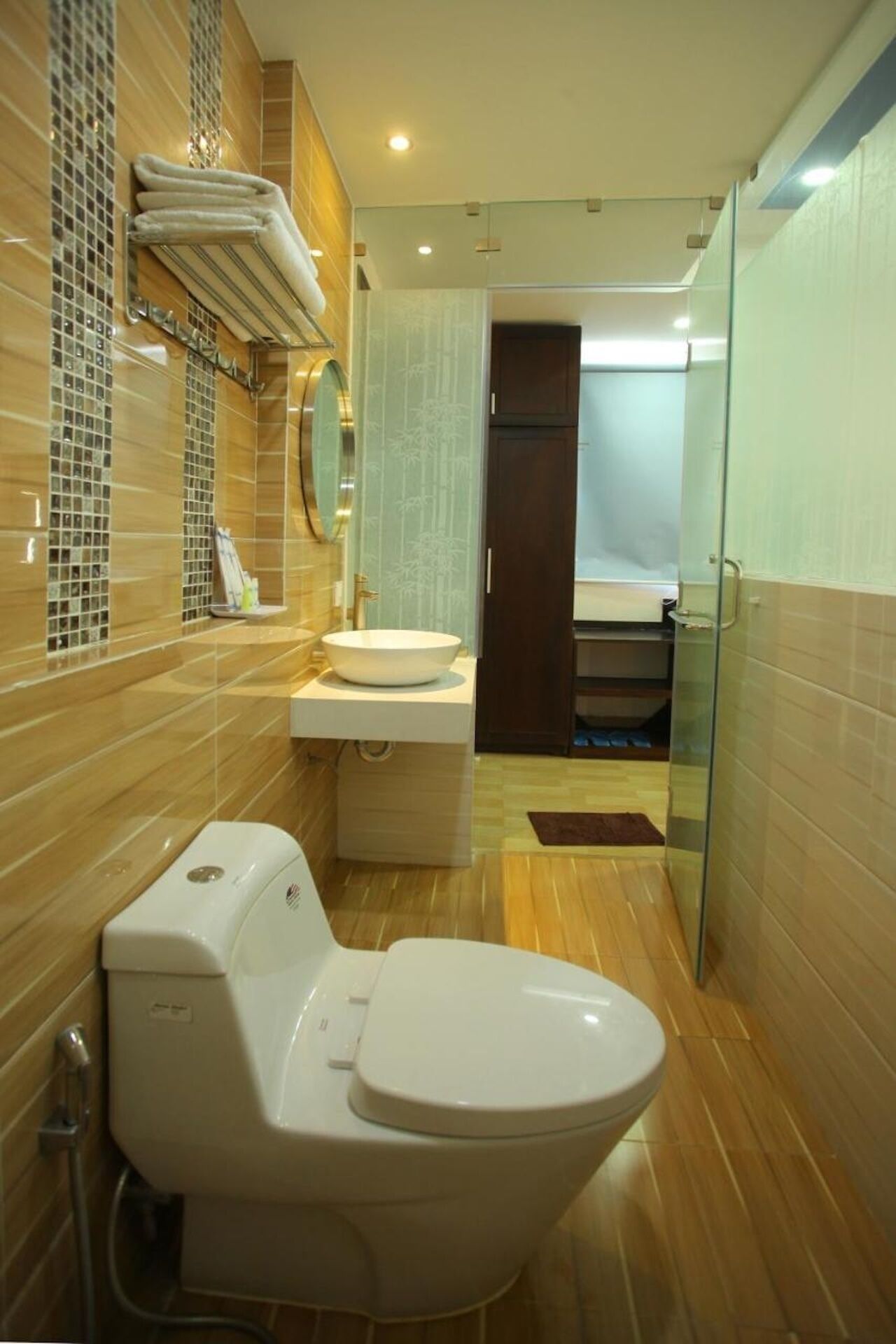 A modern bathroom with a toilet, sink, and glass shower enclosure.