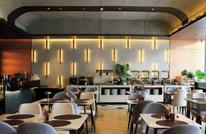 A modern restaurant interior with a bar area, seating, and a decorative wall. - Savea Bay City Manila (Paranaque)