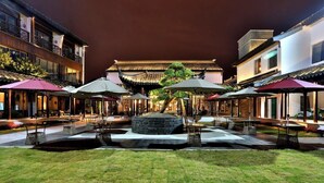 A courtyard with traditional architecture, outdoor seating, and a central fire pit. - Meshee Sezen Hotel Suzhou (Suzhou)