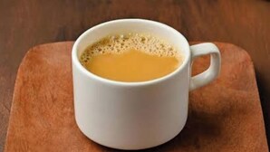 A white mug with a handle on a wooden surface. - AYUSHMAAN- Premium (Jabalpur)