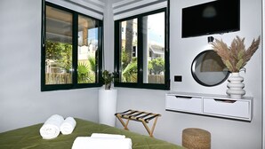 A modern bedroom with a bed, two windows, a TV, and a small bench. - El Dorado Corner (Chania)