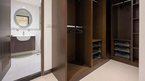 A walk-in closet with wooden doors, a hanging rack, and metal shelves.