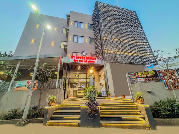 A hotel entrance with a sign for 'BY SPREE HOTELS' and a modern building with a patterned facade. - Zip By Spree Hotels Chinchwad (Pimpri - Chinchwad)