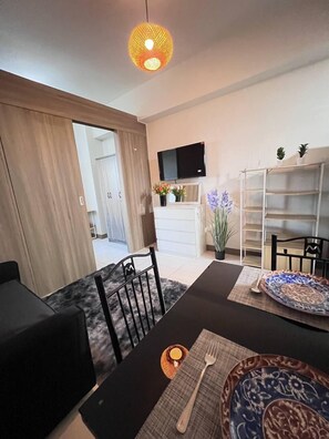 Comfort Condo, 1 Bedroom, Balcony, City View | Living area | 40-inch Smart TV with digital channels