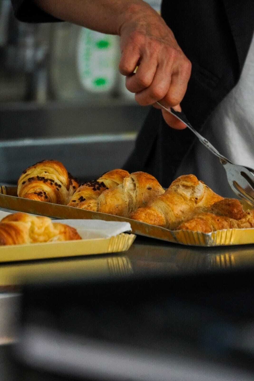 A person cutting a pastry.