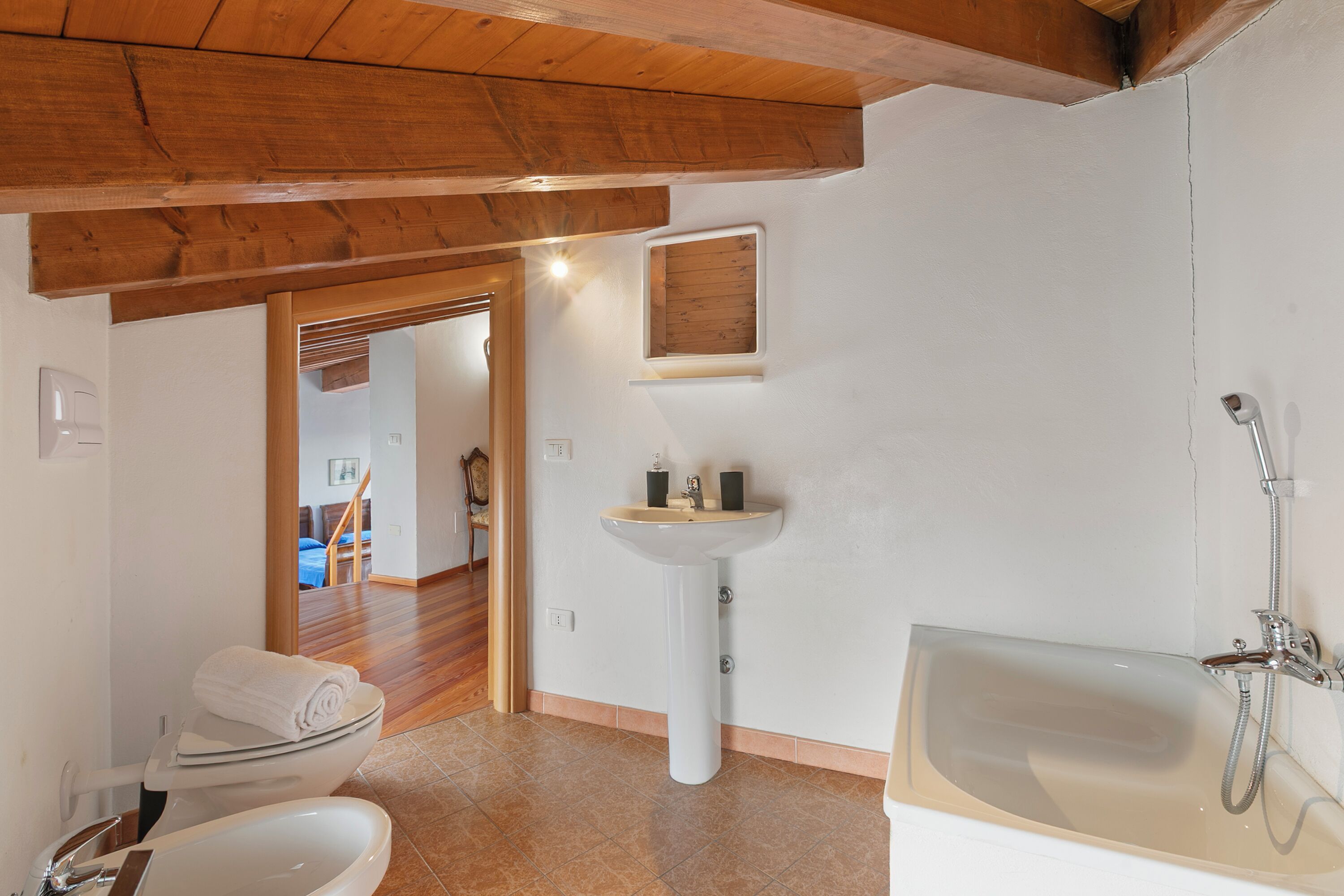 A bathroom with a toilet, sink, and bathtub.