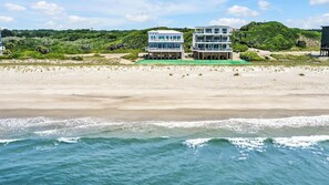 On the beach - Experience oceanfront bliss at Magic Hour, Oak Island's spacious 7-bedroom retreat for 16. (Oak Island)