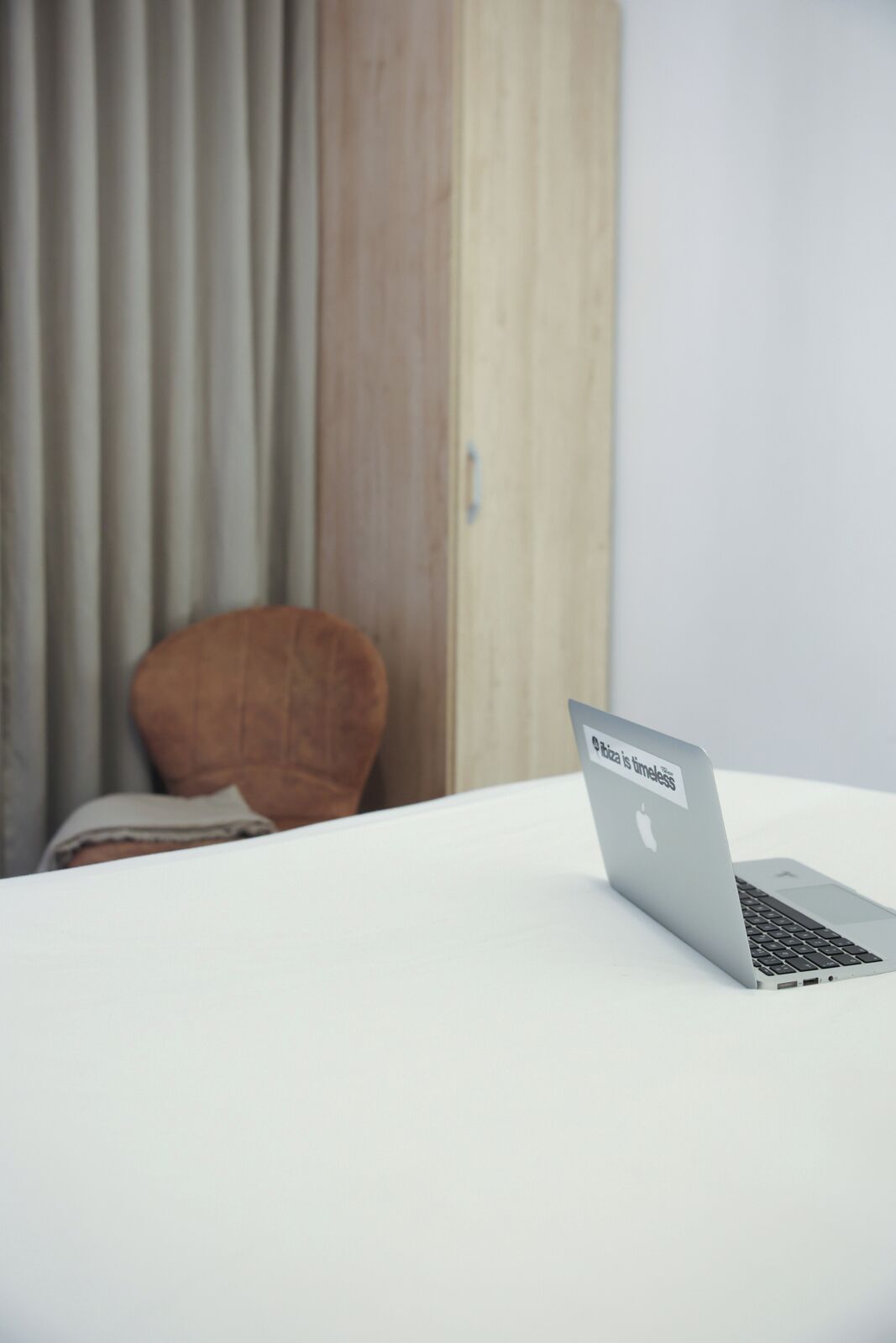 A laptop on a white table with a message on the screen.