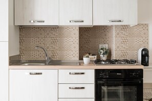 Fridge, oven, coffee/tea maker, cookware/dishes/utensils