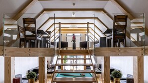 A multi-level room with a pool table, wooden furniture, and a staircase. - Rezydencja nad Wodospadem Spa&Wellness (Jelenia Gora)