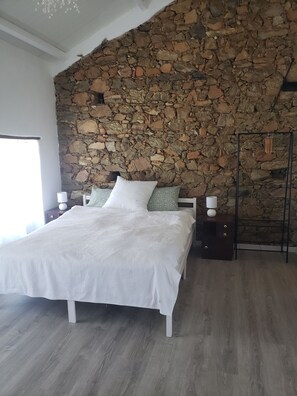 Relax in a serene bedroom with a comfortable bed, bedside tables, and a nightstand.