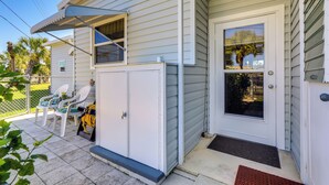 A house with a covered porch, a sliding glass door, and a small outdoor seating area with chairs. - 2 Mi to Venice Beach: Home w/ Pool Access (Venice)