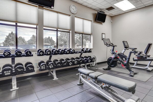 A gym with weightlifting equipment, treadmills, and dumbbells. - Ski, Hike, Golf: Redmond Escape w/ Hot Tub! (Redmond)