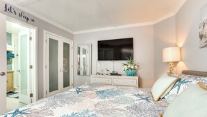 A bedroom with a bed, a TV, a dresser, and a closet. - Beach Access: Ocean-view Condo w/ Screened Balcony (Harbor Island)