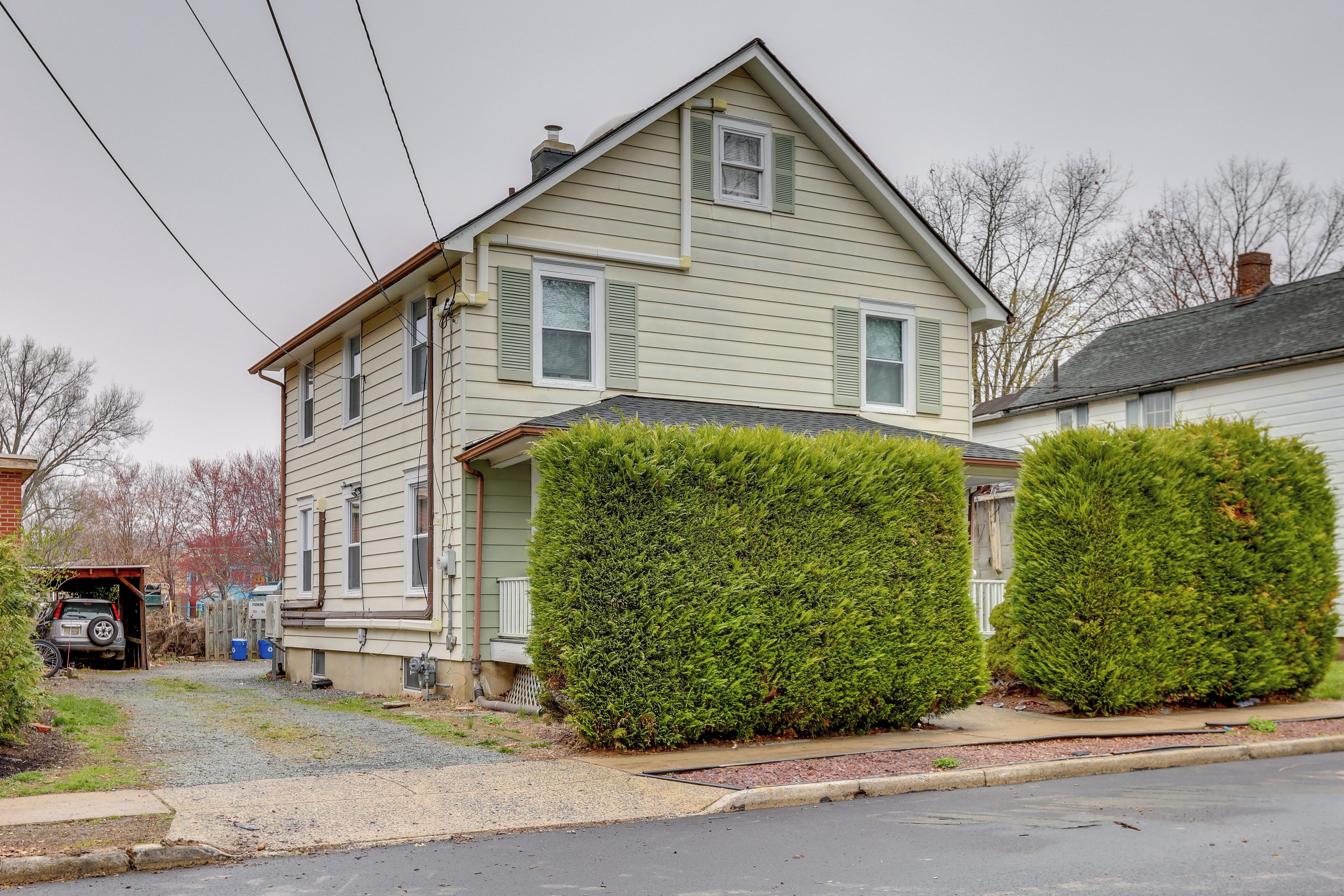 A two-story house with a garage, a driveway, and a well-maintained lawn.