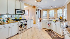 A spacious kitchen with white cabinets, stainless steel appliances, and a large island. - Theater & Game Room at Trenton Area Home (Jackson)