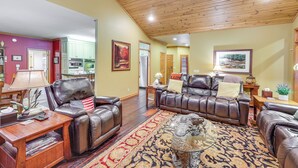 A spacious living room with leather sofas, a wooden ceiling, and a large rug. - Private Dock: 'the River House' in Heber Springs! (Heber Springs)