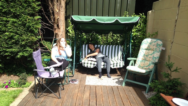 A wooden deck with two chairs and a bench. - Room-large Home in Prime Location for al (Wetherby)