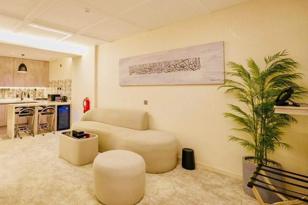 A family suite with a king bedroom, twin bedroom, hall, kitchen, and bathroom.