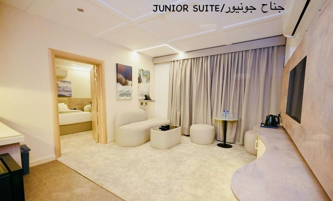 A junior suite with a king bedroom, a hall, a mini kitchen, and a bathroom.