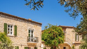 A stone building with a pool and outdoor seating. - La Grenadine Hotel (Cesme)