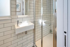 Shower, hair dryer, towels, shampoo