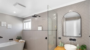 A modern bathroom with a glass shower enclosure, a freestanding bathtub, and a large mirror. - Stylish Family Retreat in Cowes w/ Backyard & BBQ (Cowes)