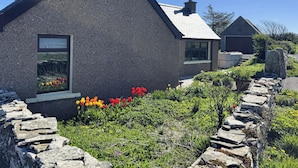 A house with a stone facade, a chimney, and a window. - Withi-gill - Bay of Ireland Views 50m From Beach (Stromness)