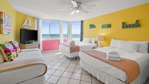A hotel room with two beds, a ceiling fan, a TV, and a view of the ocean. - Top of the Gulf by Book That Condo (Panama City Beach)