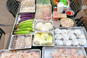 A variety of seafood and vegetables displayed on trays at a market. - Jun Yi Kai Di Hotel (Shenzhen International Convention and Exhibition Center) (Shenzhen)