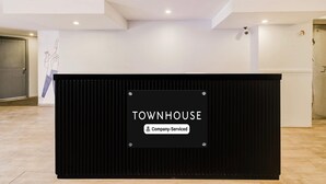 A reception desk with a sign that reads "TOWNHOUSE Company-Serviced." - Classic Lakdi Ka Pul (Hyderabad)