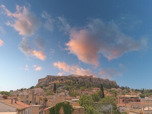 A historic cityscape with a prominent hilltop fortress.