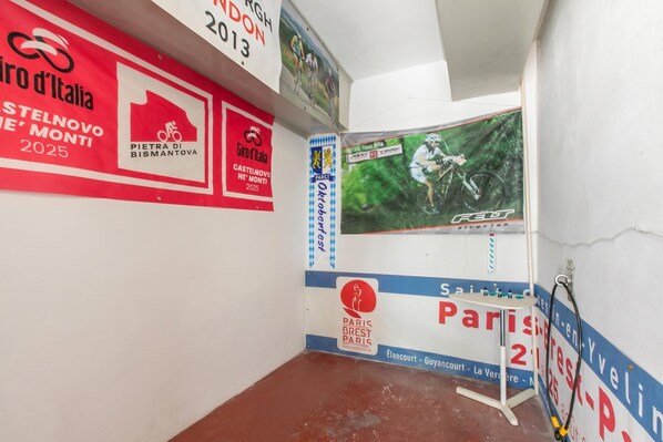 A room with a red and white wall, a small table, and a poster.