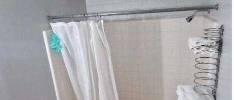 A bathroom with a shower, toilet, and sink.