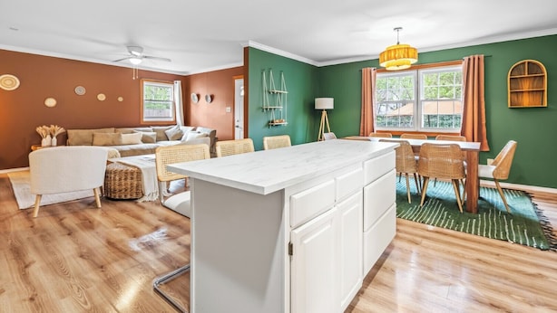 A modern living room with a sofa, dining table, and chairs.