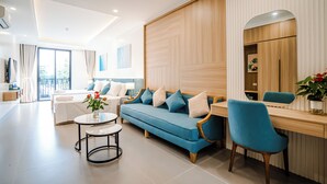 A modern living room with a sofa, a dining table, and a chair.