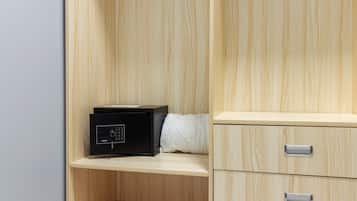 A wooden cabinet with drawers and a black electronic device on a shelf.