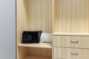 A wooden cabinet with drawers and a black electronic device on a shelf. - Coastal Escape in Tower Isle BeachNearby (Tower Isle)