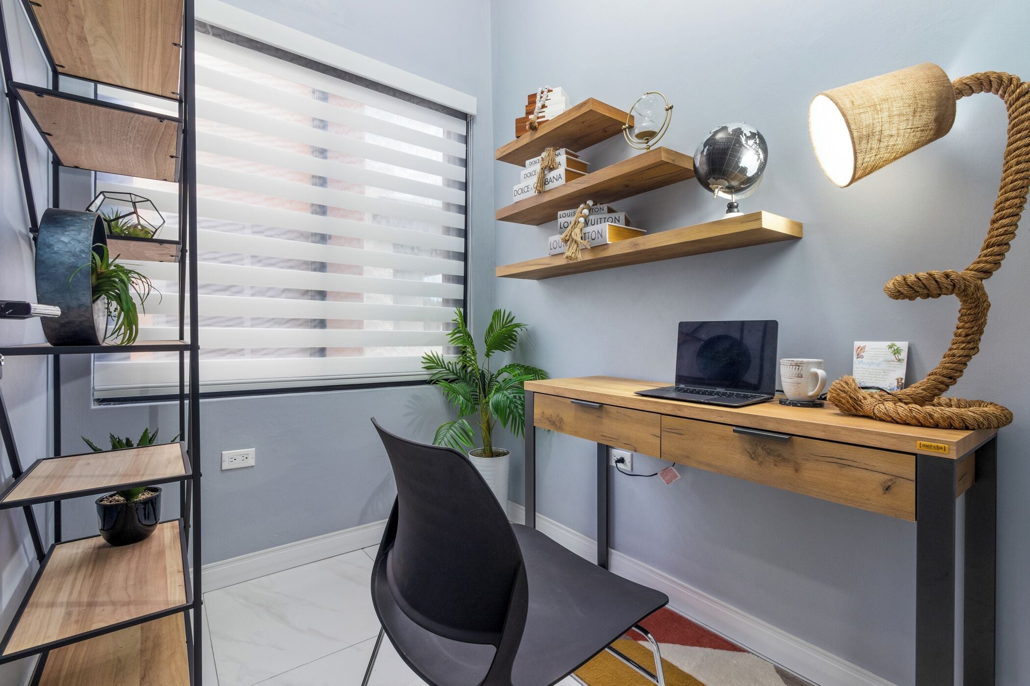 A modern office space with a desk, chair, shelves, and a lamp.