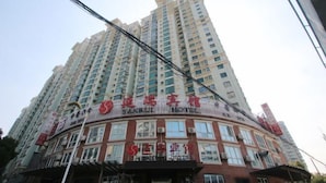 A high-rise hotel with multiple floors and balconies.