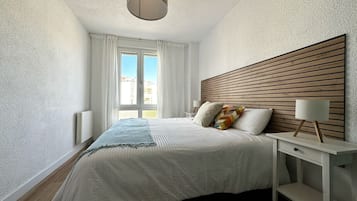 2 dormitorios, tabla de planchar con plancha, ropa de cama