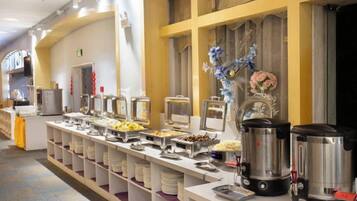 A buffet setup with various food containers and appliances.