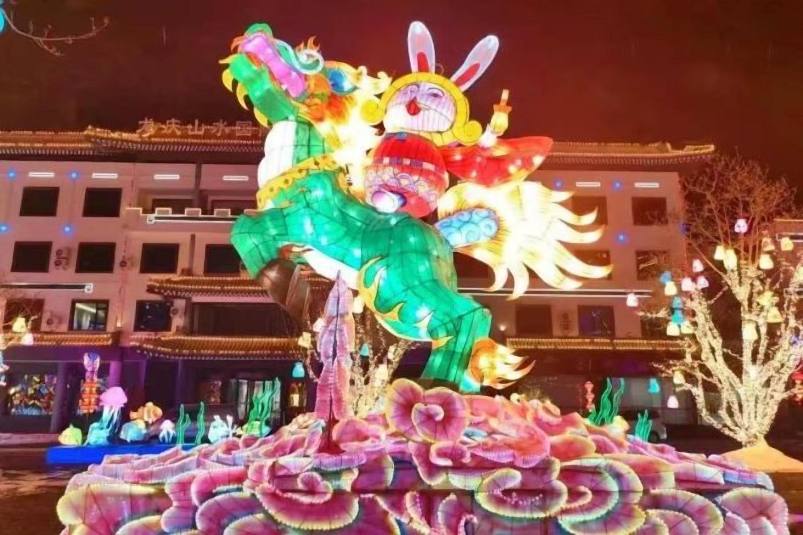 A large illuminated dragon sculpture in an outdoor setting.