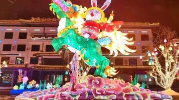 A large illuminated dragon sculpture in an outdoor setting.