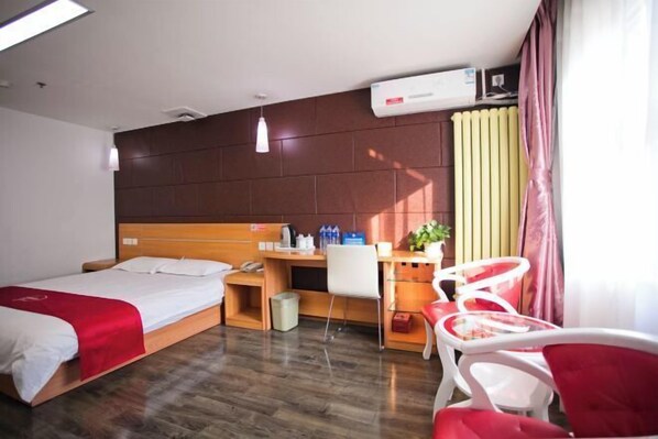 A hotel room with two beds, a desk, a chair, an air conditioner, and a window with curtains. - Manjiafu Express Hotel (Beijing)