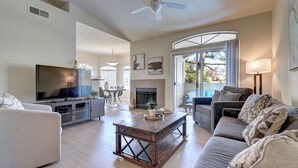 A spacious living room with a television, sofas, a coffee table, and a fireplace. - Scottsdale 3 Bdrm Condo w/Garage!  Great complex w/ Pool! (Scottsdale)